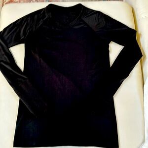 Lululemon size 6 long sleeve. Black top.  Has a very faint logo on front.